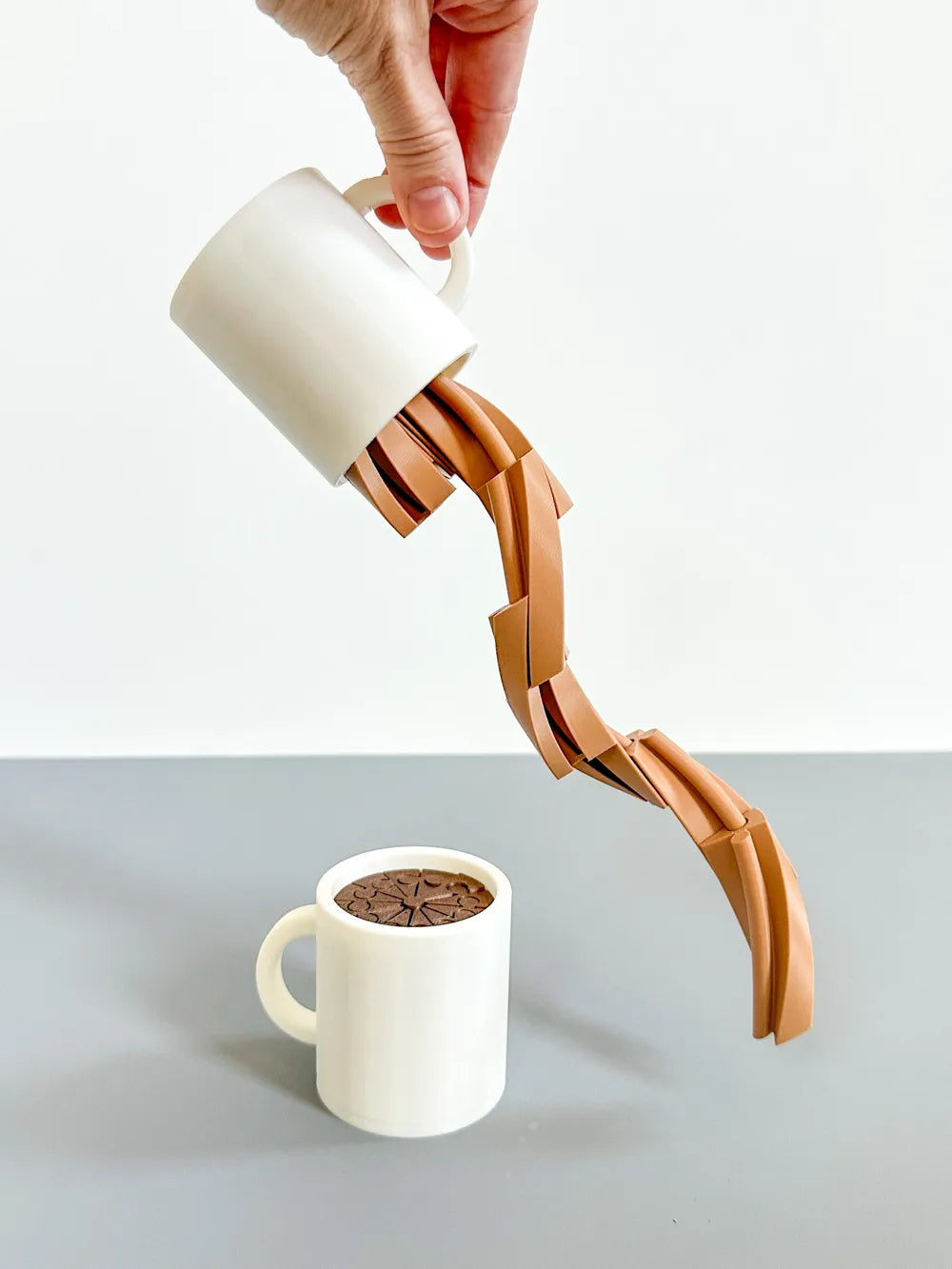 Articulated Coffee Mug Fidget extended from its holder