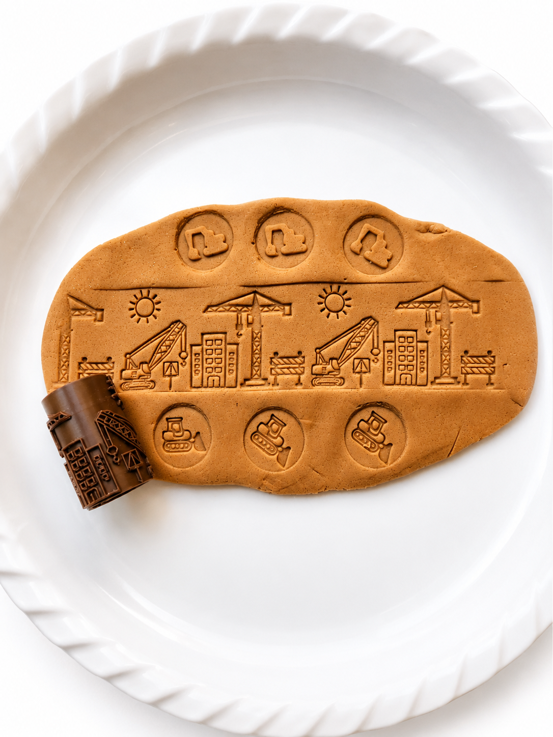 Construction scene roller pattern pressed into playdough